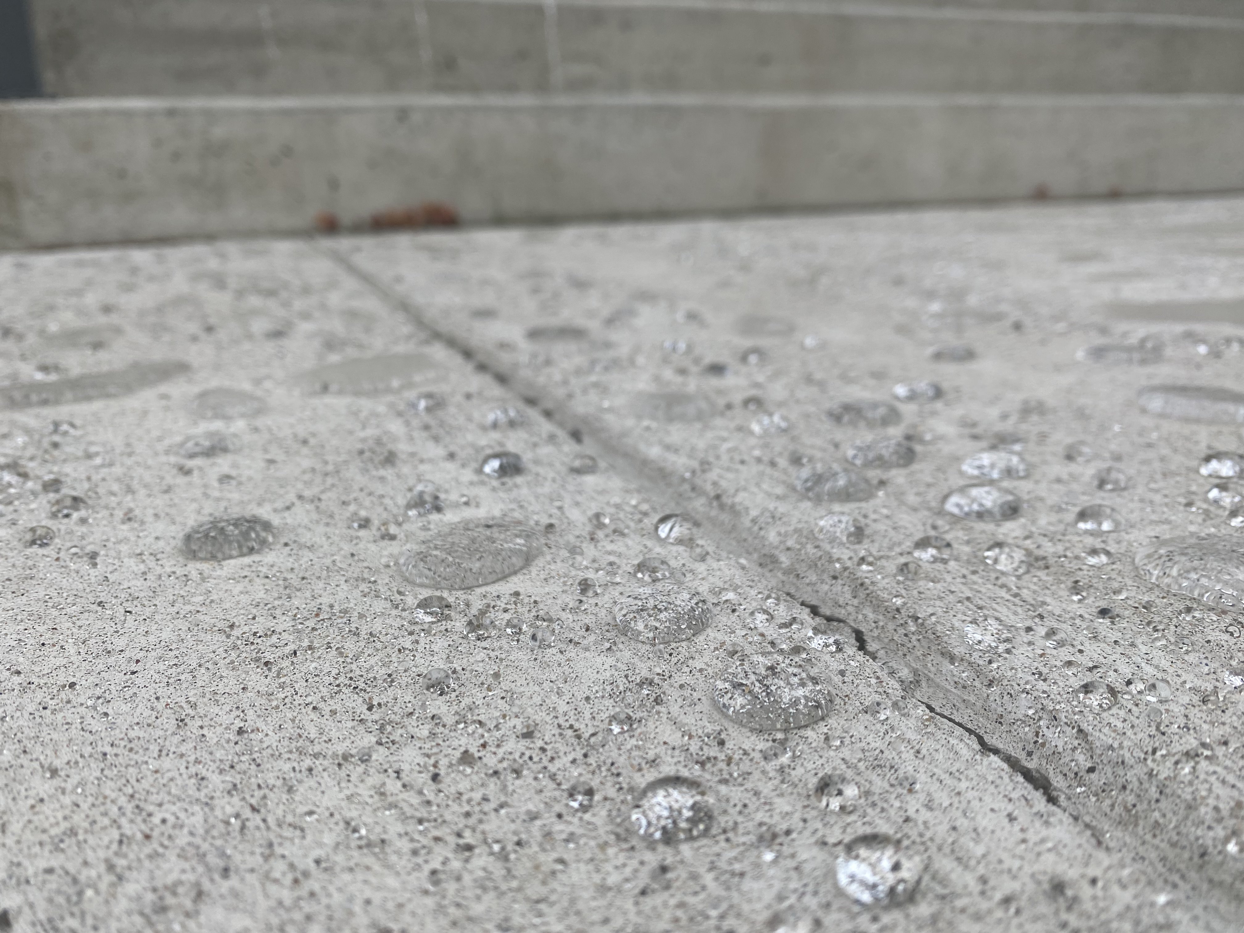 Water beading on a concrete surface after surface protection application
